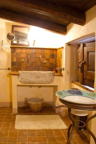 a bathroom with a sink and a tub at La Corte di Maria in Piccilli