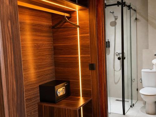 a bathroom with a shower with a clock on a box at Oceana Mazagan Suites Hôtel in El Jadida