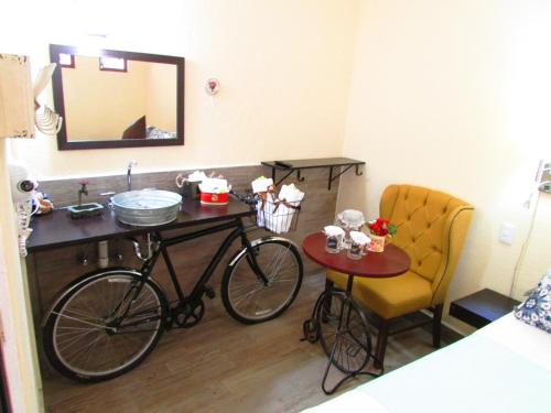 a bike in a room with a table and a chair at Hotel & Spa La Mansion del B Azul in Querétaro