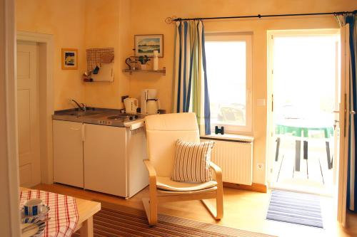 a kitchen with a table and a chair and a sink at Kleines Meer in Röbel