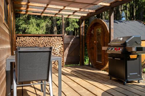 a grill and a smoker on a deck at Glamping Walden in Nový Hrozenkov