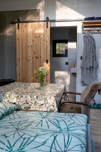 a cat standing on a chair next to a table at Glamping Walden in Nový Hrozenkov