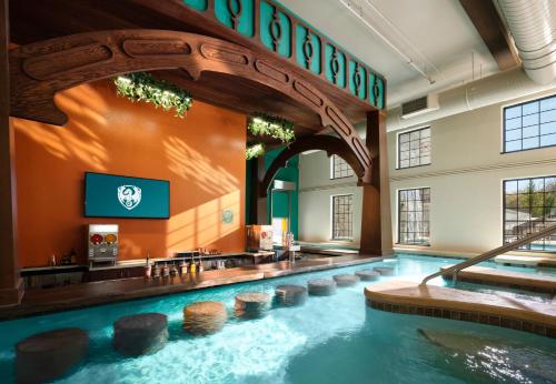 a large swimming pool in a hotel room with a swimming pool at Dellshire Resort in Wisconsin Dells