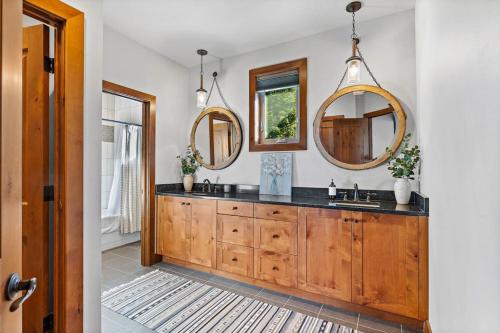 a bathroom with two sinks and two mirrors at Trailside Lodge in Cle Elum