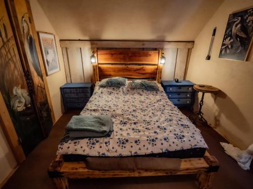 a bedroom with a large bed with a wooden headboard at Koń na biegunach in Glaznoty