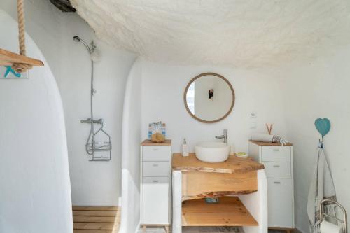 a bathroom with a sink and a mirror at Cueva Sol in Fasnia