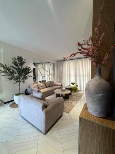 a living room with a couch and a vase at Home in Naalya in Kampala