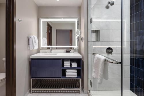 a bathroom with a sink and a mirror and a shower at Hollywood Casino Aurora in Aurora