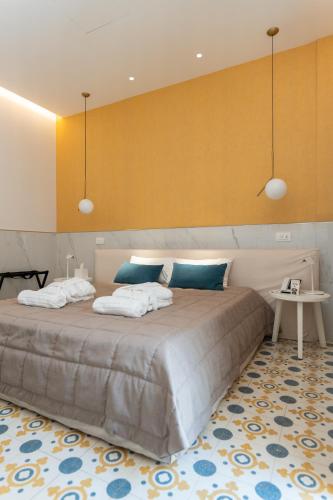 a bedroom with a large bed with two towels at Villa Ascosa - Relais sul Mare in Trani