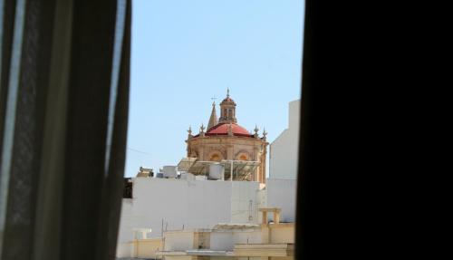 a view of a building from a window at Balzanija Boutique Accommodation in Balzan