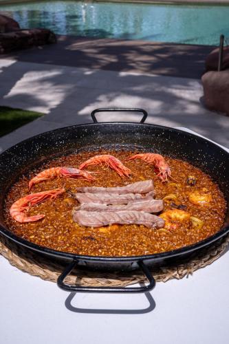 a pan of food with shrimp on top of it at Hotel Alicante Golf in Alicante