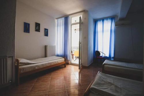 a room with a bed and a sliding glass door at Hotel Riva in Stenje