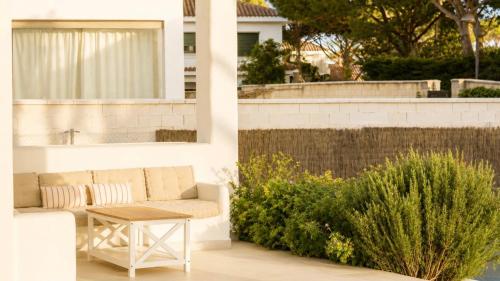 a patio with a couch and a table at Villa Guvalmar Chalet Roche in Roche