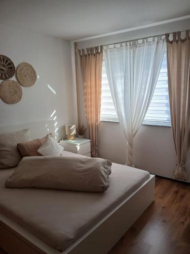 a bedroom with a large bed and a window at Wohlfühloase mit Sauna in Mayen