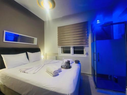 a bedroom with a white bed and a window at Phoenix Garden Apartments - 4 - in Athens