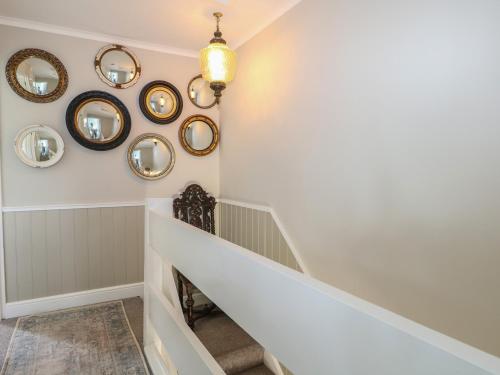 a hallway with mirrors and a stairway at The Dacha in Winchester