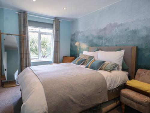 a bedroom with a large bed with a painting on the wall at The Dacha in Winchester