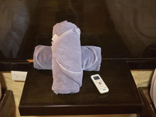 a towel on a table next to a remote control at Chuk-Kay by ÓOL Hotels in Holbox Island