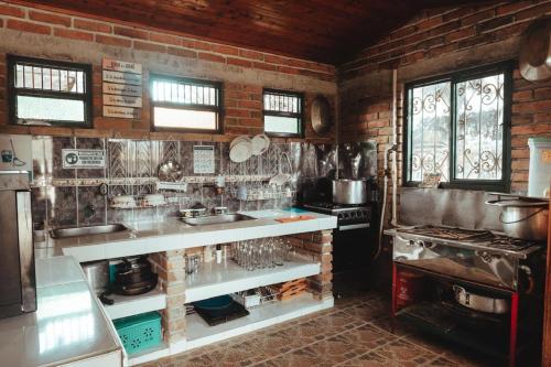 a kitchen with brick walls and a counter and a stove at Chalet Alto Bonito in Pueblorrico