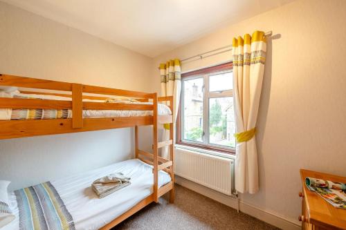a bedroom with two bunk beds and a window at 3 Bed in Seaton oc-mbdal in Seaton