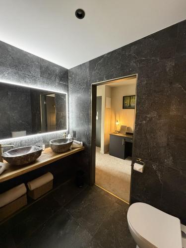 a bathroom with two sinks and a toilet at House 15 in Kenmare