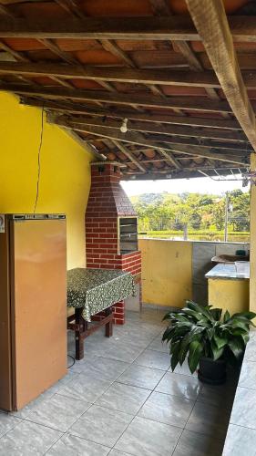 a patio with a bench and a brick oven at Recanto 2 irmãos in Socorro