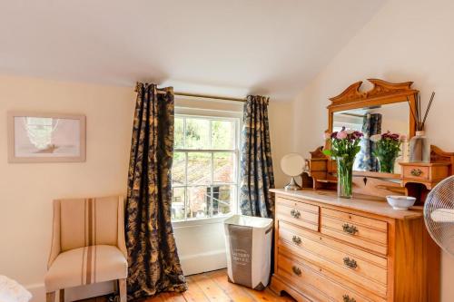 a bedroom with a dresser with a mirror and a window at 1 Bed in Elstronwick oc-e42580 in Burton Pidsea