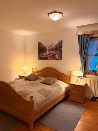 a bedroom with a wooden bed and two night stands at Ferienhaus Sophia & Ilse in Murau