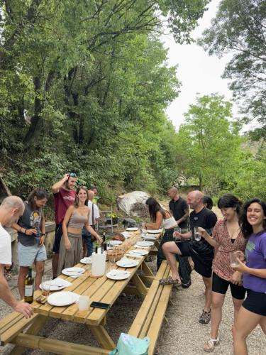 a group of people standing around a long picnic table at Hogar del Sol in Pamplona