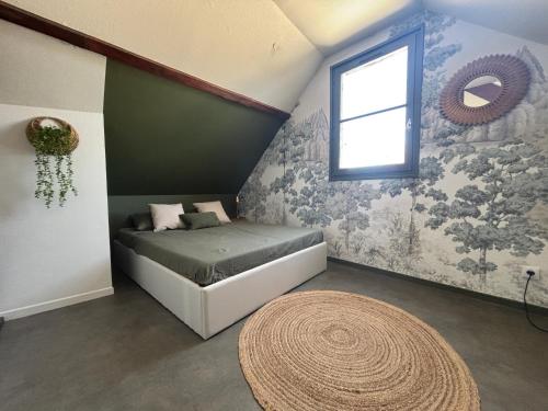 a bedroom with a bed and a window and a rug at La haute république in Brive-la-Gaillarde