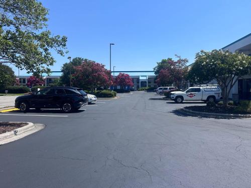 a street with cars parked in a parking lot at Studio 6 Suites Jacksonville, NC - Camp LeJeune in Jacksonville
