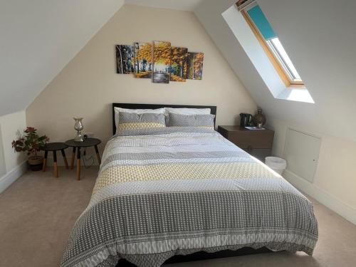 a bedroom with a large bed in a attic at Modern Private Rooms in Chelmsford with Workspace & Free Parking in Chelmsford