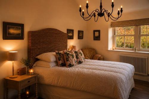 a bedroom with a bed and a chandelier at The Summerhouse in Keighley