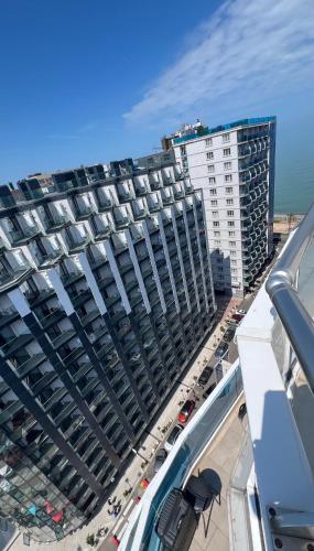 a large building with cars parked in a parking lot at 2 минуты до моря in Batumi