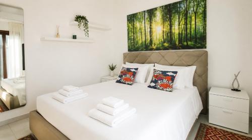 a bedroom with a white bed with towels on it at Sunrise Apartment by Symphonya Luxury Holiday Rentals in Otranto