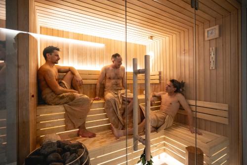 a group of people sitting in a sauna at El Nido wellness a spa in Vysoké Mýto
