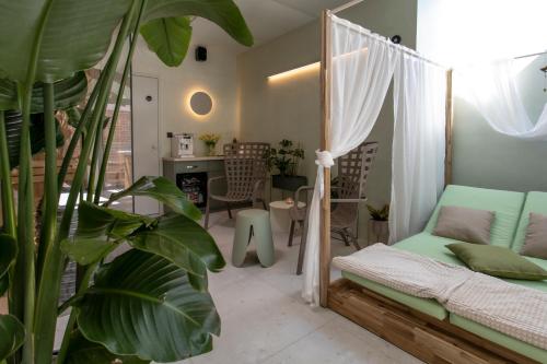 a room with a bed and a room with a plant at El Nido wellness a spa in Vysoké Mýto