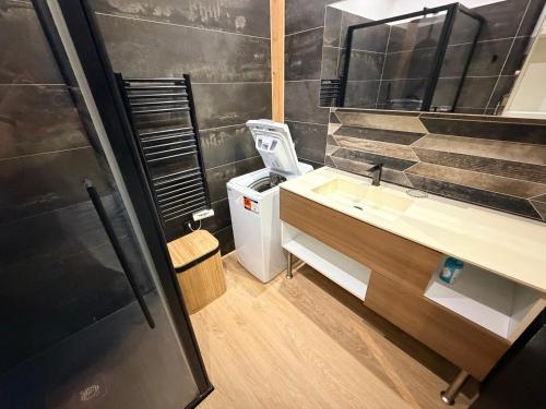 a bathroom with a sink and a mirror at Studio LA PETITE PAUSE in Ajaccio
