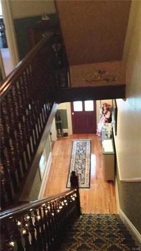 a stairway with a person standing in a room at Hillcrest Bed and Breakfast in Jim Thorpe