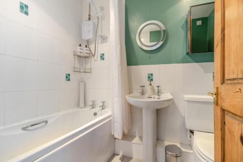a bathroom with a sink and a toilet and a tub and a sink at 2 Bed in Richards Castle oc-r45225 in Lane to Richards Castle