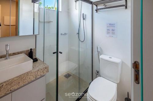 a bathroom with a shower and a toilet and a sink at Modern studio in a condominium with pool MSU0701 in Governador Valadares
