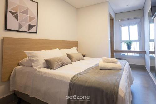 a bedroom with a large bed with two pillows on it at Apto w/ A/C in Anápolis Downtown GRLB1802 in Anápolis