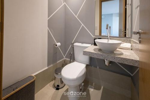 a bathroom with a toilet and a sink at Apto w/ A/C in Anápolis Downtown GRLB1802 in Anápolis