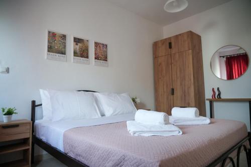 a bedroom with a bed with two towels on it at Meltemi by GG in Alexandroupoli