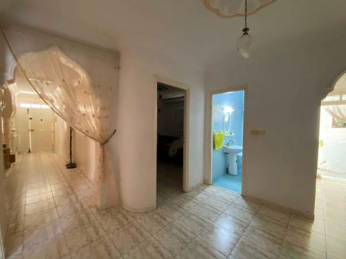 an empty room with a white wall and a doorway at Vacation home in Kelibia