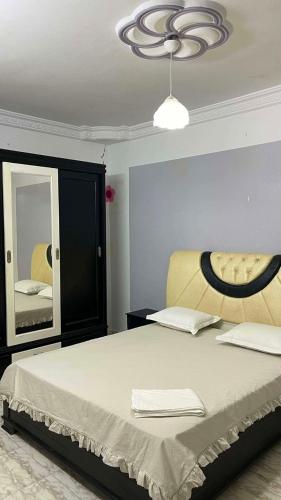a bedroom with a large bed and a mirror at Vacation home in Kelibia