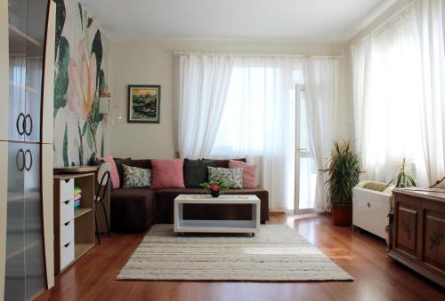 a living room with a couch and a table at Sunny Day Apartment in Pomorie