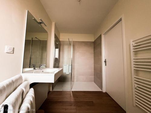 a bathroom with a sink and a mirror at Claïla Appart-Hôtel Abzac in Abzac