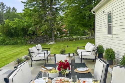 a patio with chairs and a table with food on it at Bluestone Cottage in Goshen
