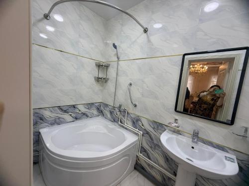 a bathroom with a toilet and a sink and a mirror at Khudzhand City in Khujand